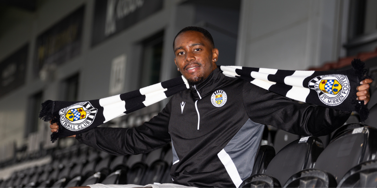 Jaden Brown poses with a St Mirren scarf after returning to the club